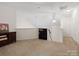 Upper-level hallway with carpeting and built-in shelving at 8509 Loxton Cir, Charlotte, NC 28214