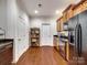 Modern kitchen with wood cabinets, granite countertops, and black appliances at 8509 Loxton Cir, Charlotte, NC 28214