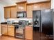 Well-equipped kitchen featuring wood cabinets and black appliances at 8509 Loxton Cir, Charlotte, NC 28214