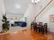 Open concept living and dining area with hardwood floors at 8509 Loxton Cir, Charlotte, NC 28214