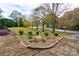 Landscaped front yard with a stone birdbath and manicured hedges at 101 Hidden Cove Dr, Shelby, NC 28150