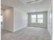 Large bedroom with grey carpet and two windows at 115 Ciara Pl # C, Mooresville, NC 28117