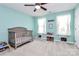 Bedroom with crib, toy storage, and ceiling fan at 1707 Scarbrough Sw Cir, Concord, NC 28025