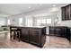 Open kitchen with breakfast bar and views into living area at 1707 Scarbrough Sw Cir, Concord, NC 28025