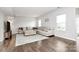 Living room featuring a sectional sofa and hardwood floors at 1707 Scarbrough Sw Cir, Concord, NC 28025