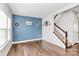 Living area with hardwood floors and an accent wall at 1707 Scarbrough Sw Cir, Concord, NC 28025