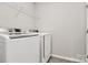 Laundry room with washer, dryer, and shelving at 1707 Scarbrough Sw Cir, Concord, NC 28025