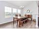 Bright dining room with wood table and bench seating at 1707 Scarbrough Sw Cir, Concord, NC 28025
