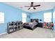 Light blue bedroom with a bed, dresser, and ceiling fan at 1707 Scarbrough Sw Cir, Concord, NC 28025