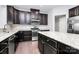 Modern kitchen featuring granite countertops, stainless steel appliances, and dark wood cabinetry at 1707 Scarbrough Sw Cir, Concord, NC 28025