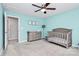 Light blue bedroom with a crib and dresser at 1707 Scarbrough Sw Cir, Concord, NC 28025