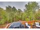 Deck overlooking wooded area with built-in grill and seating at 18568 Mainsail Ct, Lancaster, SC 29720