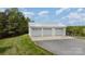 Detached three-car garage with a metal roof at 28399 Flint Ridge Rd, Albemarle, NC 28001