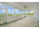 Screened porch with ceiling fan and scenic view at 28399 Flint Ridge Rd, Albemarle, NC 28001