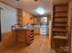 Kitchen with wood cabinets, white appliances, and wood-look flooring at 5201 Allen E Rd, Charlotte, NC 28269