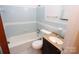 Clean bathroom with light blue tiled walls, a bathtub, and a vanity with sink at 82 Allen Pond Rd, Wadesboro, NC 28170