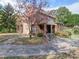 Brick home with stone details, a tree in the front yard, and a stone walkway at 1116 E Franklin Blvd, Gastonia, NC 28054