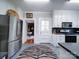Bright kitchen with white cabinets, stainless steel appliances, and patterned rug at 1116 E Franklin Blvd, Gastonia, NC 28054