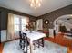 Bright dining room with hardwood floors, a large window, and a view of the living room at 1116 E Franklin Blvd, Gastonia, NC 28054