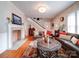 Cozy living room with hardwood floors, fireplace, and large windows at 1116 E Franklin Blvd, Gastonia, NC 28054