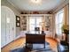 Spacious home office with hardwood floors, built-in shelving, and an arched entryway at 1116 E Franklin Blvd, Gastonia, NC 28054