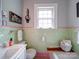 Bathroom with mint green tile and a built-in wood shelf at 1116 E Franklin Blvd, Gastonia, NC 28054