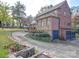 Brick house with stone accents, a two-car garage, and a long driveway at 1116 E Franklin Blvd, Gastonia, NC 28054