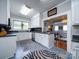 Well-lit kitchen with white cabinets, dark countertops, and an open floor plan at 1116 E Franklin Blvd, Gastonia, NC 28054