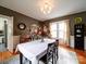 Elegant dining room with a chandelier, hardwood floors, and large windows at 1116 E Franklin Blvd, Gastonia, NC 28054