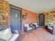 Front porch with brick flooring and wicker seating at 1116 E Franklin Blvd, Gastonia, NC 28054
