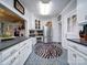 Galley kitchen with white cabinets, stainless steel appliances, and tile floors at 1116 E Franklin Blvd, Gastonia, NC 28054