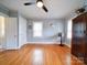 Hardwood floors, ceiling fan, and built-in wooden wardrobe at 1116 E Franklin Blvd, Gastonia, NC 28054