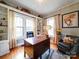 Bright home office features built-in shelves, hardwood floors, and large windows at 1116 E Franklin Blvd, Gastonia, NC 28054