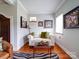 Cozy living room featuring a white couch and hardwood floors at 1116 E Franklin Blvd, Gastonia, NC 28054
