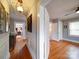 Bright hallway with hardwood floors, showing access to bedrooms and bathroom at 1116 E Franklin Blvd, Gastonia, NC 28054