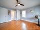 Spacious bedroom with hardwood floors, ceiling fan, and ample closet space at 1116 E Franklin Blvd, Gastonia, NC 28054