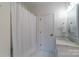 Bathroom with shower, vanity, and adjacent door at 17418 Sailors Watch Pl, Cornelius, NC 28031