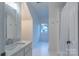 Clean bathroom with shower/tub combo, vanity, and window at 17418 Sailors Watch Pl, Cornelius, NC 28031