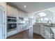 Modern kitchen boasts stainless steel appliances and white cabinetry at 17418 Sailors Watch Pl, Cornelius, NC 28031
