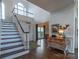 Two-story entryway with hardwood floors, staircase, and formal dining room at 17418 Sailors Watch Pl, Cornelius, NC 28031