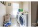 Bright laundry room with washer, dryer, and ample storage at 18023 Train Station Dr, Cornelius, NC 28031