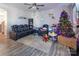 Cozy living room with fireplace, sectional sofa, and Christmas tree at 18023 Train Station Dr, Cornelius, NC 28031