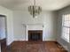 Living room features hardwood floors, a fireplace, and a large chandelier at 223 Chester Ave, Great Falls, SC 29055