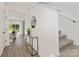 Bright entryway with hardwood floors, staircase, and a console table at 6611 Terry Ln, Charlotte, NC 28215