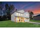 Two-story house with light-colored siding, brick accents, and a two-car garage at 6611 Terry Ln, Charlotte, NC 28215