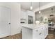 Modern kitchen with white cabinets, island, and stainless steel appliances at 6611 Terry Ln, Charlotte, NC 28215