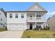 Two story white house with gray accents and balcony at 122 W Heart Pine Ln, Statesville, NC 28677