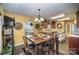 Open concept kitchen with island, wood cabinets, and a dining area at 12413 Stowe Acres Dr, Charlotte, NC 28262