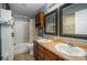 Bathroom with double sinks, a bathtub, and a shower at 12413 Stowe Acres Dr, Charlotte, NC 28262