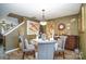 Elegant dining room with a glass table and gray upholstered chairs at 12413 Stowe Acres Dr, Charlotte, NC 28262